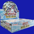 Yu-Gi-Oh! TRADING CARD GAME Justice Hunters booster box display, showing an open retail box with multiple sealed booster packs inside. The box artwork features multiple characters from the set, including the large dragon-like Dracotail Arthalion in the background, K9-17 “Ripper” in the center, and several small, colorful Yummy monsters in the foreground, set against a light blue and white futuristic background.